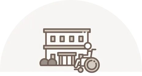 高齢者施設と車椅子の利用者を表すイラスト